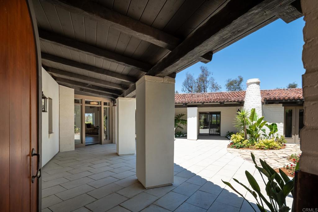 5002 El Acebo Rancho Santa Fe, CA 92067 - Photo 42 of 55 a view of a porch with dining table and chairs