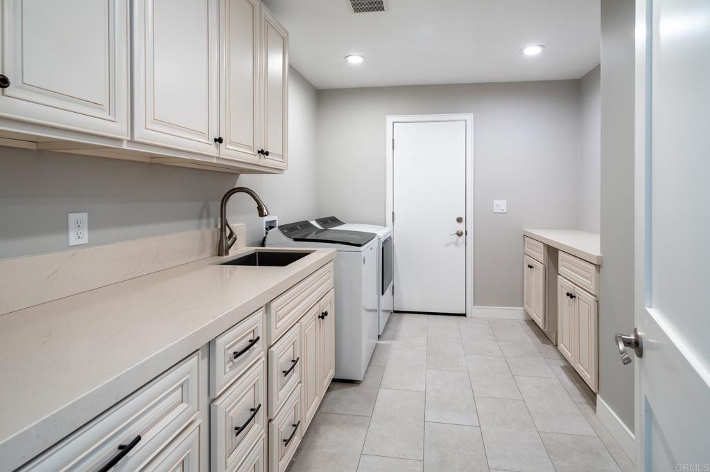 5002 El Acebo Rancho Santa Fe, CA 92067 - Photo 48 of 55 a kitchen with white cabinets