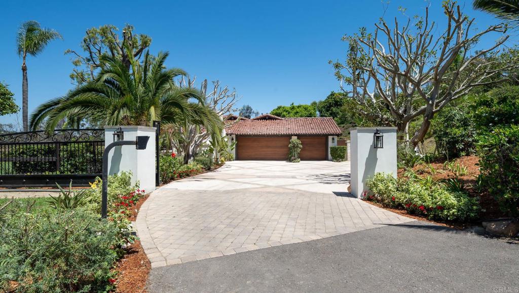 5002 El Acebo Rancho Santa Fe, CA 92067 - Photo 51 of 55 a front view of a house with a yard and garage