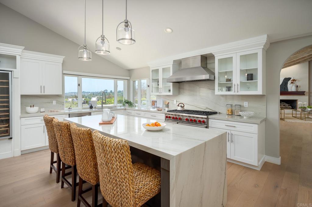 5002 El Acebo Rancho Santa Fe, CA 92067 - Photo 9 of 55 a kitchen with stainless steel appliances granite countertop a stove refrigerator and cabinets