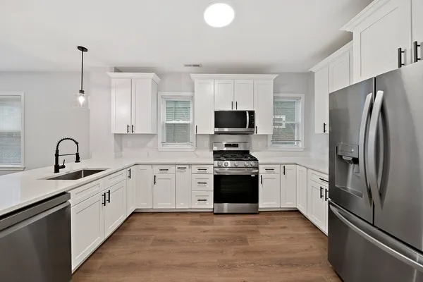 a kitchen with a refrigerator stove and sink
