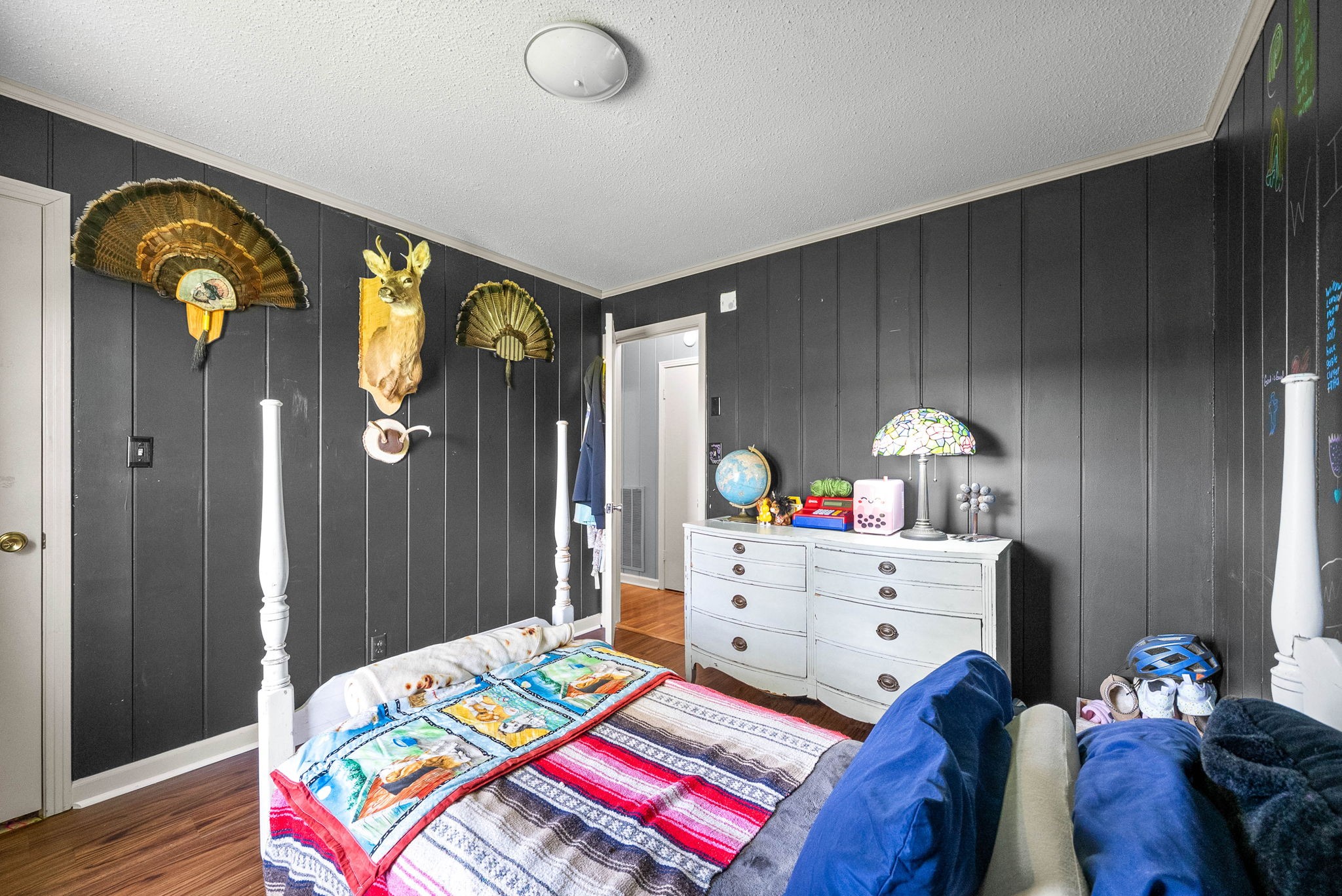 558 Bumpus Road Cunningham, TN 37052 - Photo 39 of 64 a bedroom with a bed and a chandelier