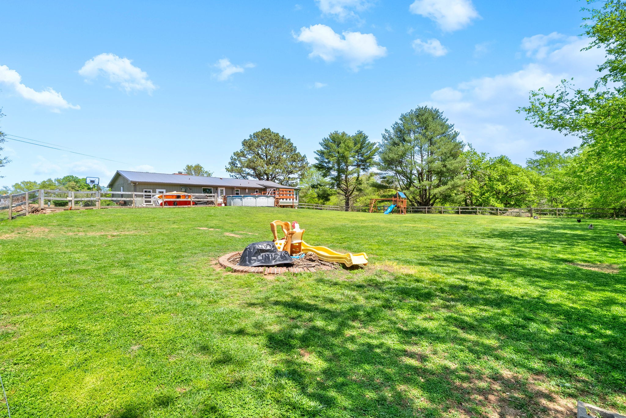 558 Bumpus Road Cunningham, TN 37052 - Photo 49 of 64 a view of a golf course with a wooden fence