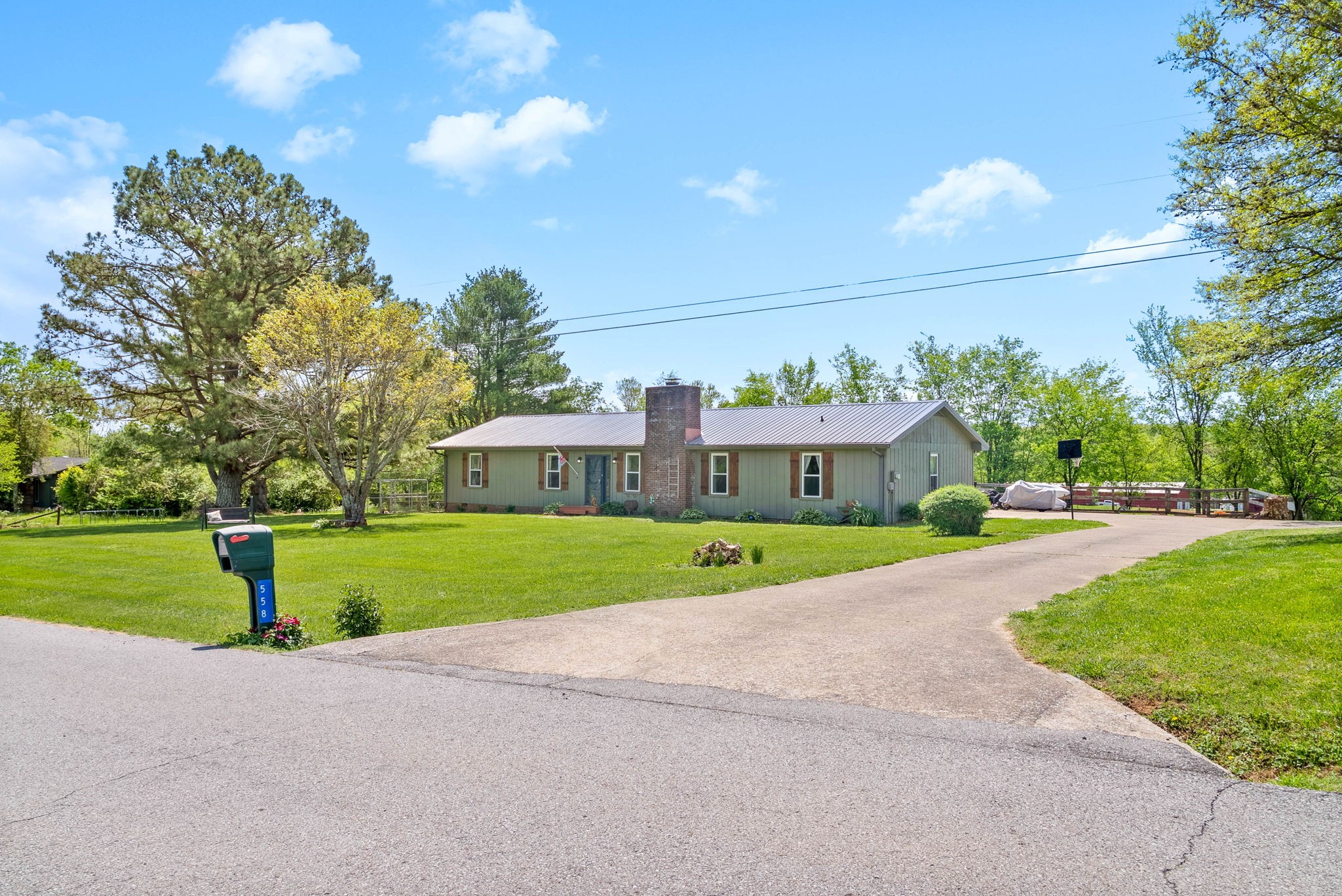 558 Bumpus Road Cunningham, TN 37052 - Photo 5 of 64 a view of a house with a big yard plants and large trees