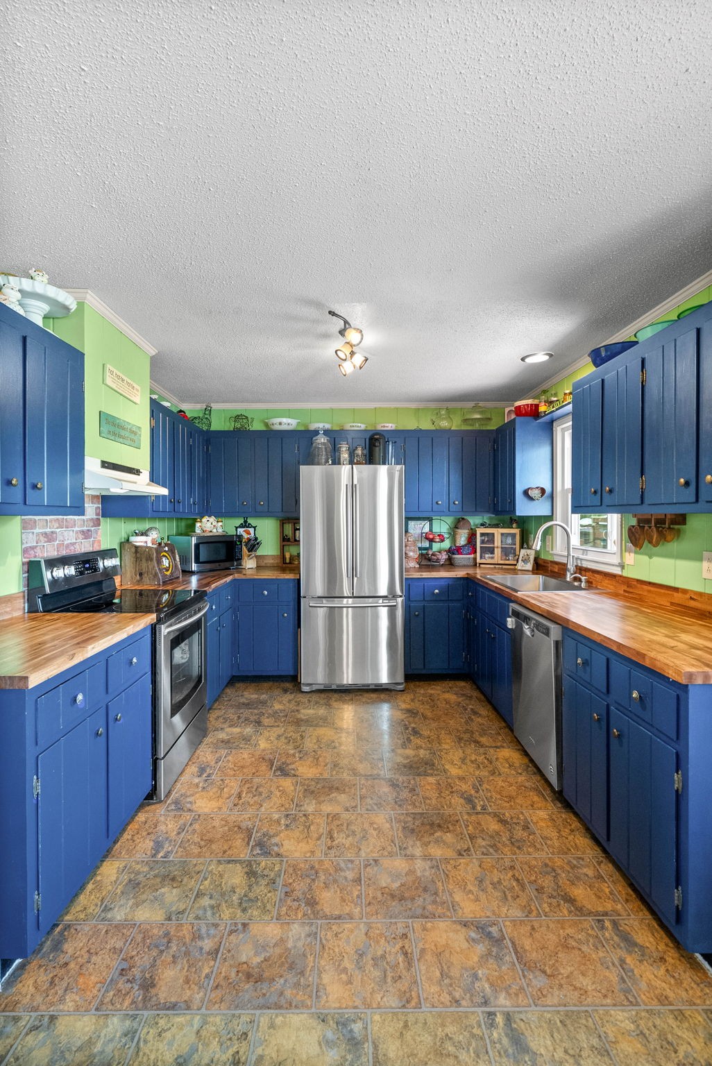 558 Bumpus Road Cunningham, TN 37052 - Photo 54 of 64 a large kitchen with stainless steel appliances and a refrigerator