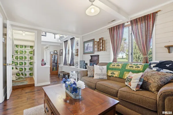 a kitchen with stainless steel appliances granite countertop a stove top oven a sink dishwasher a refrigerator and cabinets with wooden floor