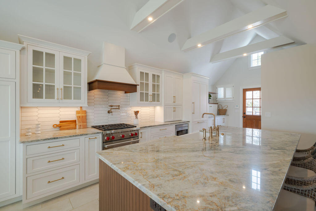 39 Bay Shore Road Hyannis, MA 02601 - Photo 11 of 63 a kitchen with granite countertop a stove a sink a dining table and chairs
