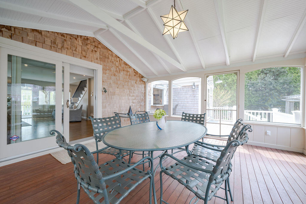 39 Bay Shore Road Hyannis, MA 02601 - Photo 18 of 63 a dining room with furniture a chandelier and wooden floor