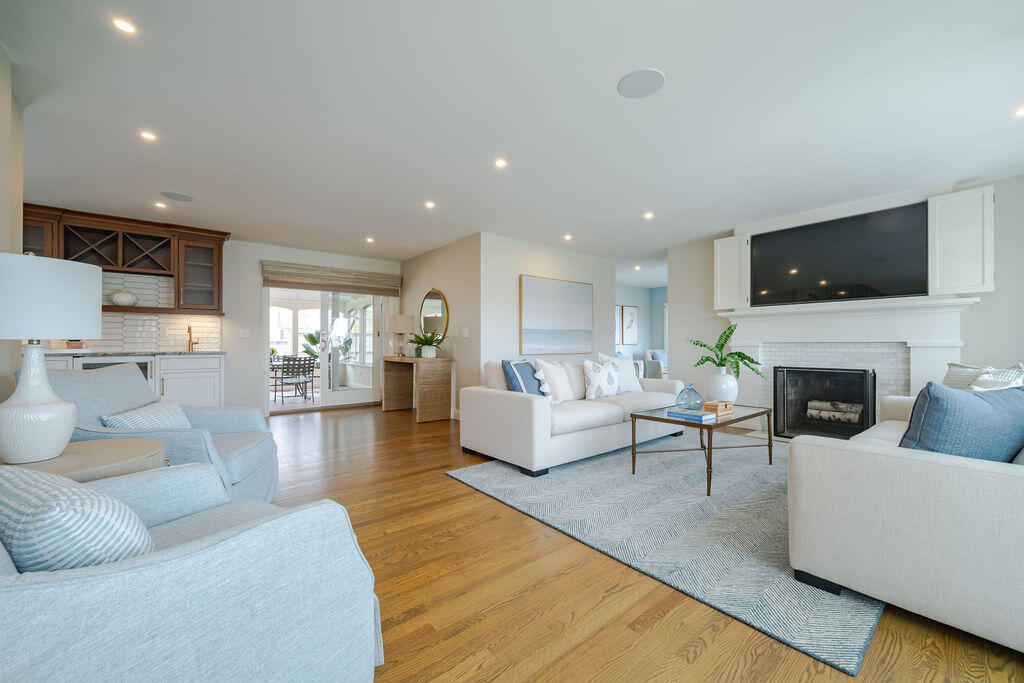 39 Bay Shore Road Hyannis, MA 02601 - Photo 19 of 63 a living room with furniture a flat screen tv and a fireplace