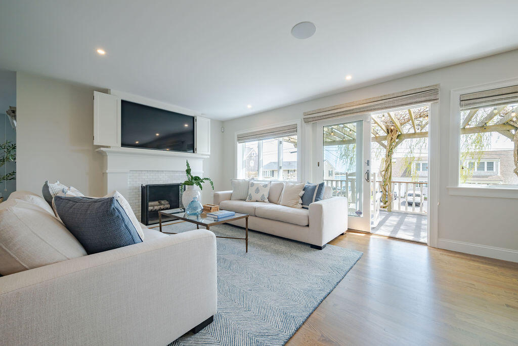 39 Bay Shore Road Hyannis, MA 02601 - Photo 20 of 63 a living room with furniture a flat screen tv and a fireplace