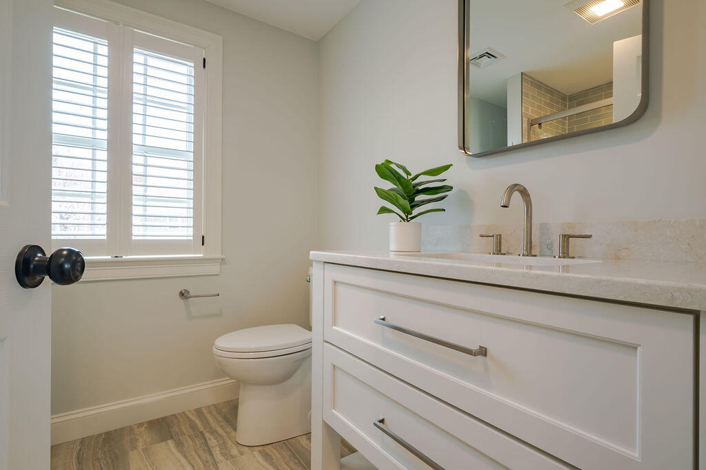 39 Bay Shore Road Hyannis, MA 02601 - Photo 35 of 63 a bathroom with a granite countertop toilet sink and mirror