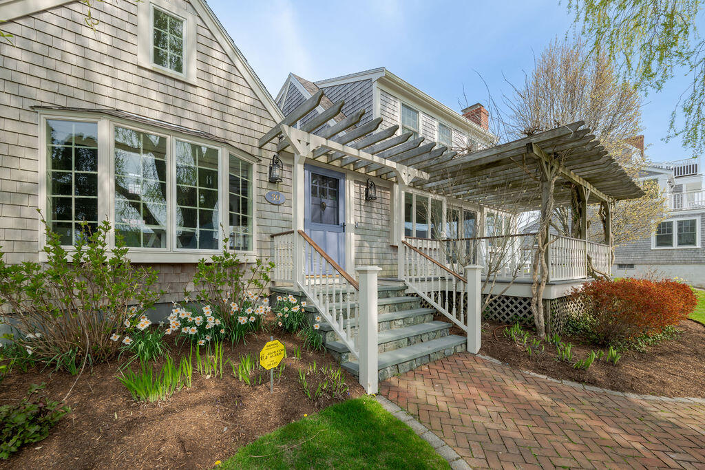 39 Bay Shore Road Hyannis, MA 02601 - Photo 4 of 63 a view of a house with a small yard and floor to ceiling window and wooden fence