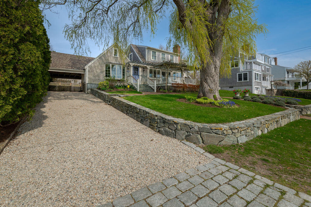39 Bay Shore Road Hyannis, MA 02601 - Photo 42 of 63 a front view of a residential apartment building with a yard and large trees
