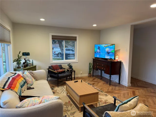 a living room with furniture and a flat screen tv