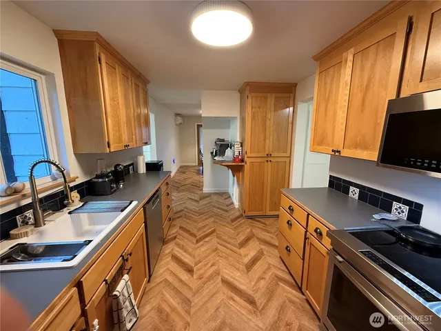 a bed room with a bed and a flat tv screen on the dresser