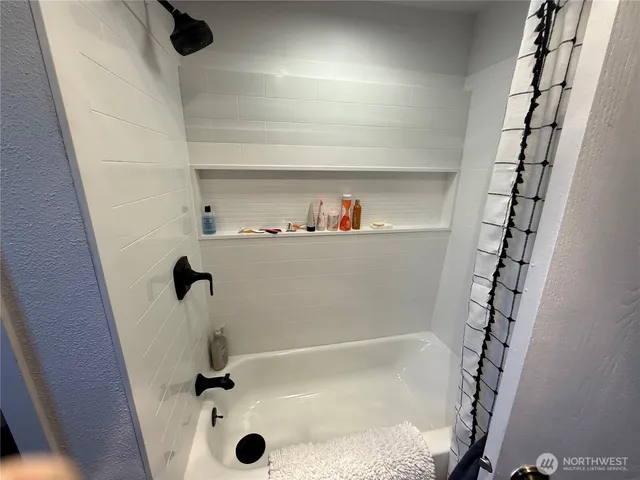 a bathroom with a bathtub and a shower