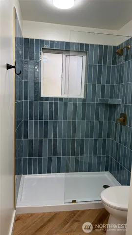 a bathroom with a toilet and shower