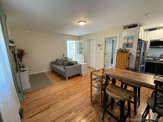 86 Pocahontas Road Redding, CT 06896 - Photo 11 of 23 a living room with furniture a flat screen tv and a refrigerator
