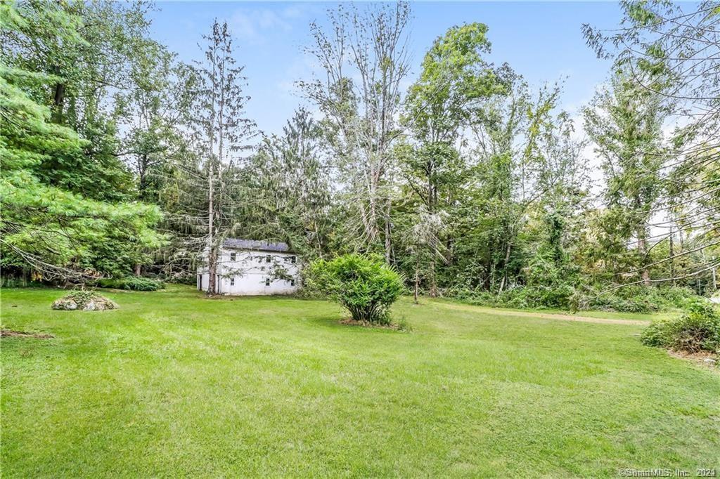 86 Pocahontas Road Redding, CT 06896 - Photo 13 of 23 a big yard with lots of green space and plants