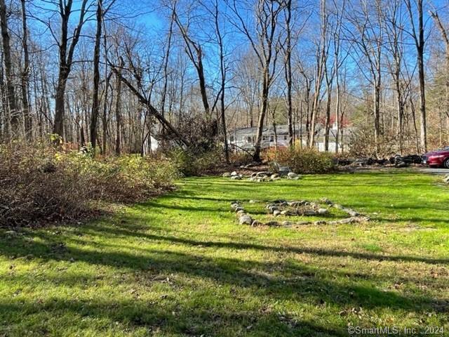 86 Pocahontas Road Redding, CT 06896 - Photo 15 of 23 a backyard of apartments with large trees