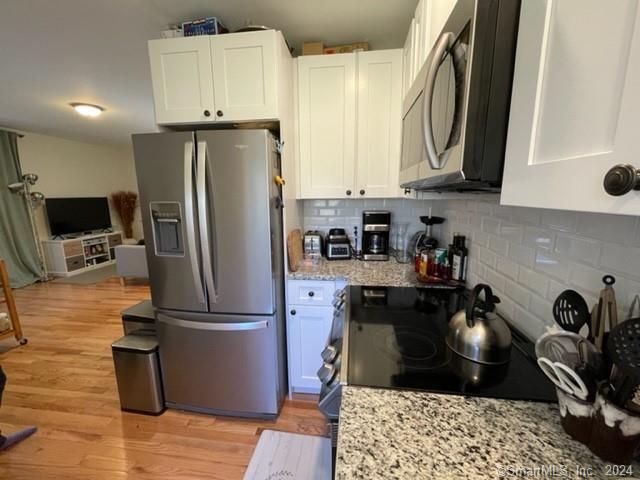 86 Pocahontas Road Redding, CT 06896 - Photo 5 of 23 a kitchen with stainless steel appliances a refrigerator a sink a stove and cabinets