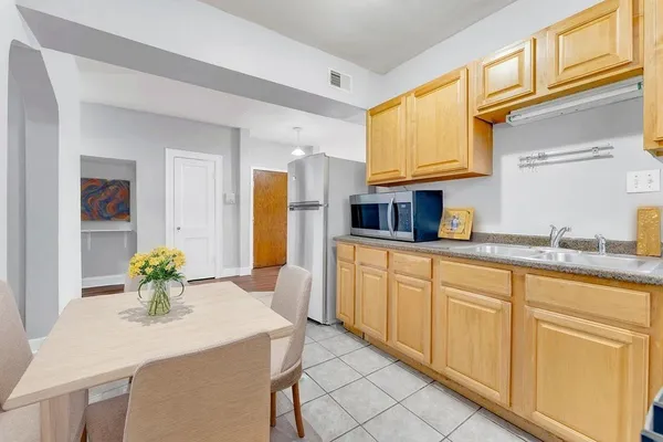 a kitchen with cabinets and center island