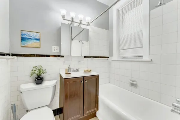 a bathroom with a sink a toilet and bathtub