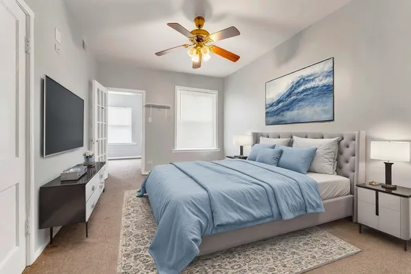 a bedroom with bed and a flat screen tv