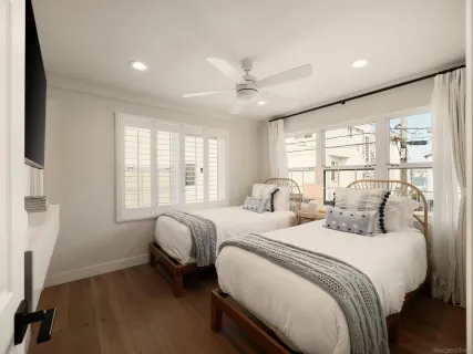 a bedroom with two beds and a large window