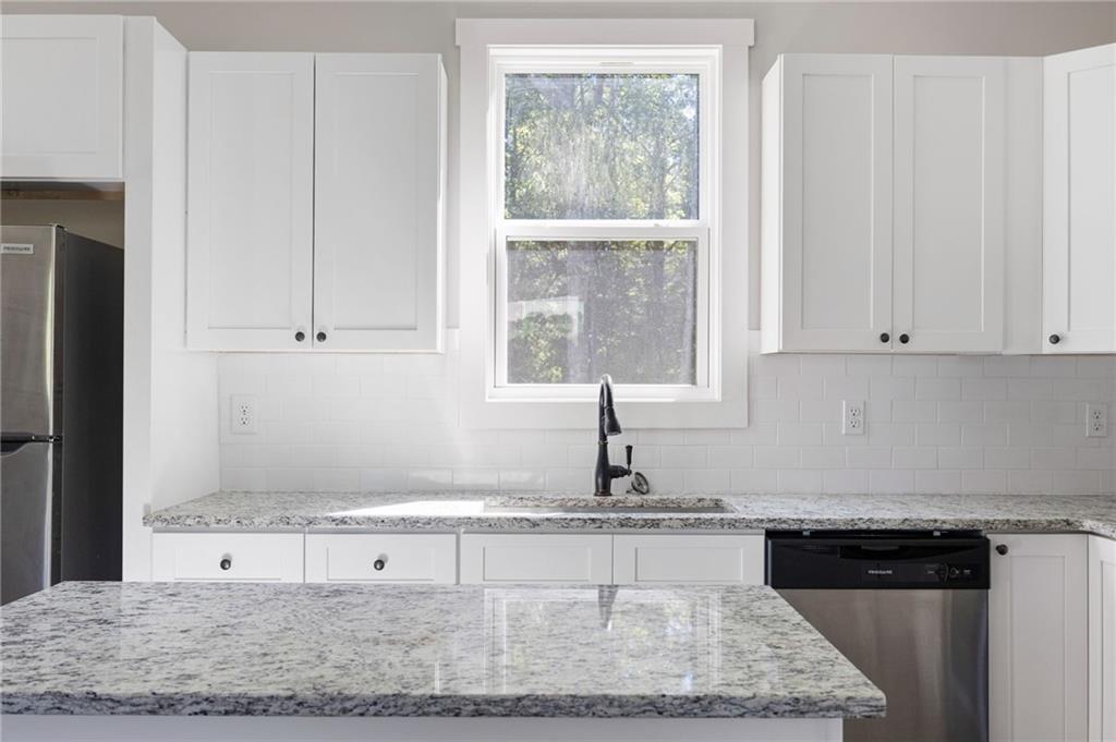 205 Pinecrest Road Cedartown, GA 30125 - Photo 14 of 27 a kitchen with granite countertop a sink white cabinets and a granite counter tops