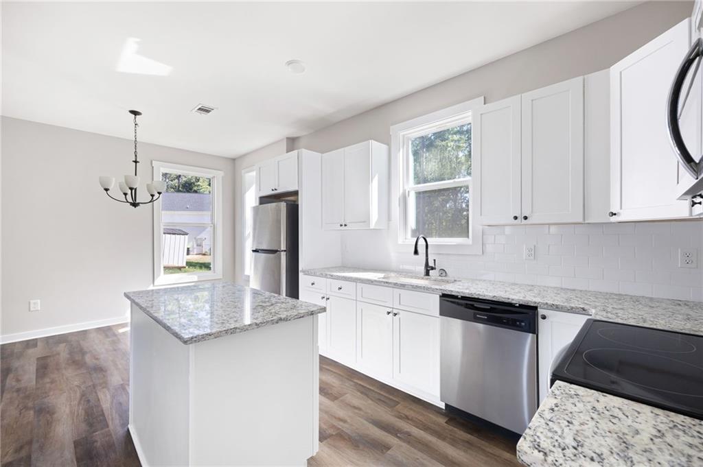 205 Pinecrest Road Cedartown, GA 30125 - Photo 15 of 27 a kitchen with stainless steel appliances granite countertop a sink stove and refrigerator