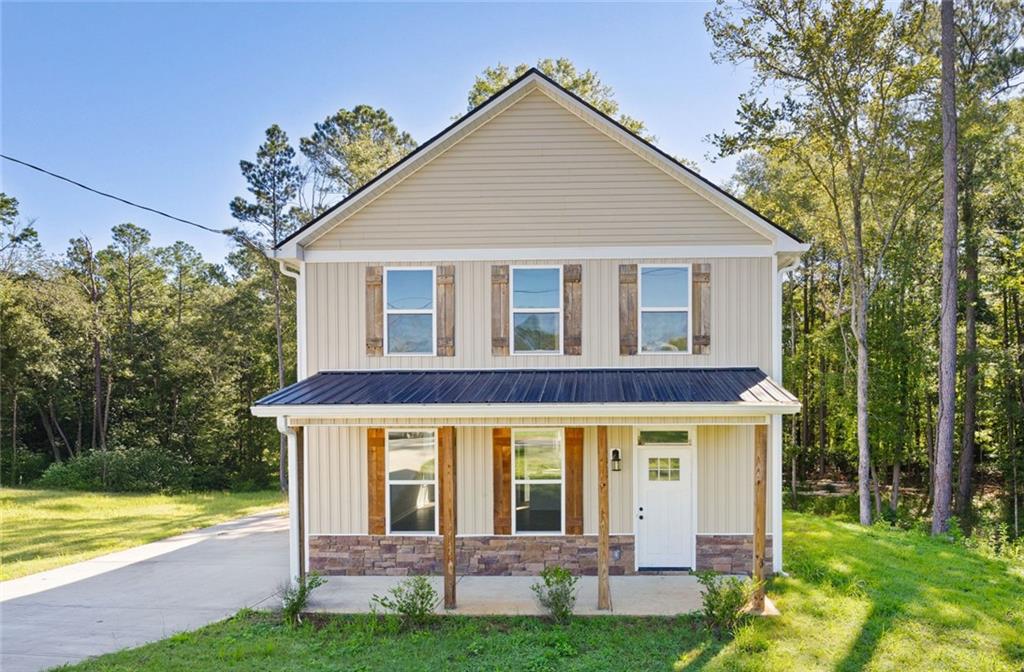 205 Pinecrest Road Cedartown, GA 30125 - Photo 2 of 27 a view of a yard in front of a house with plants and large tree