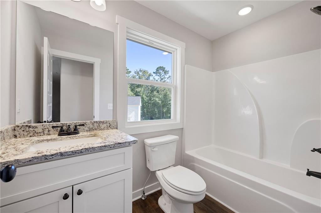 205 Pinecrest Road Cedartown, GA 30125 - Photo 23 of 27 a bathroom with a granite countertop toilet sink and mirror with bathtub
