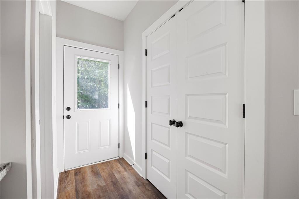 205 Pinecrest Road Cedartown, GA 30125 - Photo 25 of 27 a view of a hallway with wooden floor and closet area