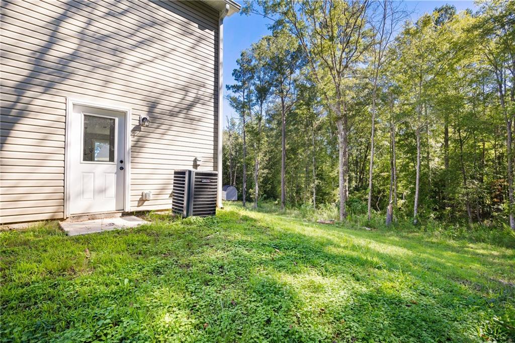 205 Pinecrest Road Cedartown, GA 30125 - Photo 26 of 27 a view of a backyard with plants and large tree