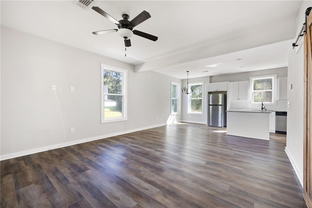205 Pinecrest Road Cedartown, GA 30125 - Photo 9 of 27 a view of an empty room with window and wooden floor