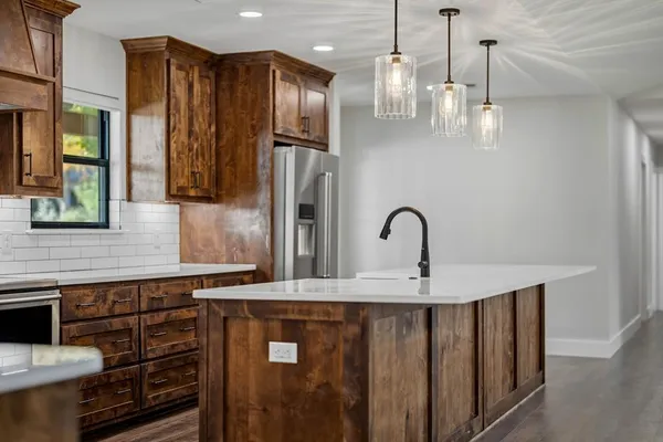 a close view of a sink and a refrigerator