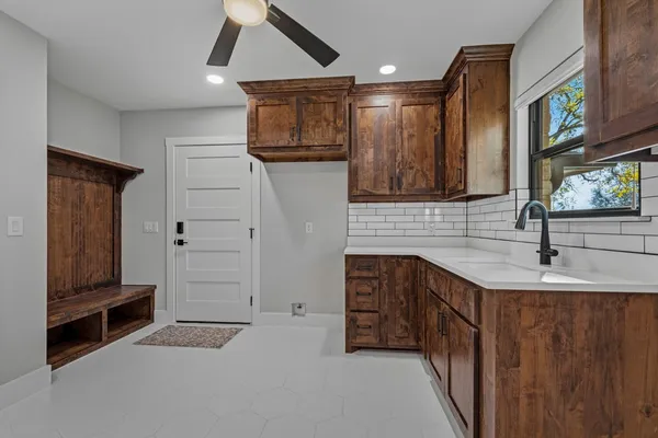 a kitchen with stainless steel appliances a sink and a refrigerator