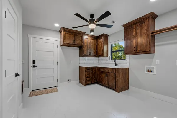 a living room with furniture and a ceiling fan