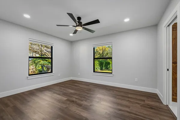 wooden floor in an empty room with a window