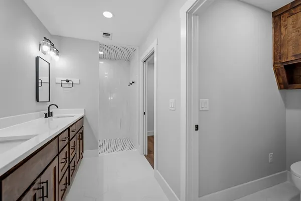 a bathroom with a sink a mirror and a bathtub