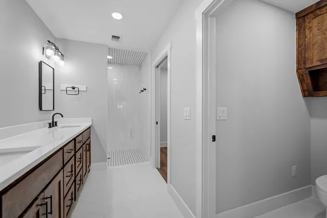 a bathroom with a sink a mirror and a bathtub