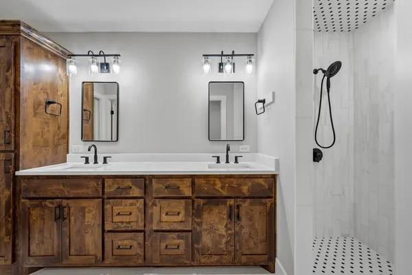 a bathroom with a double vanity sink and a mirror