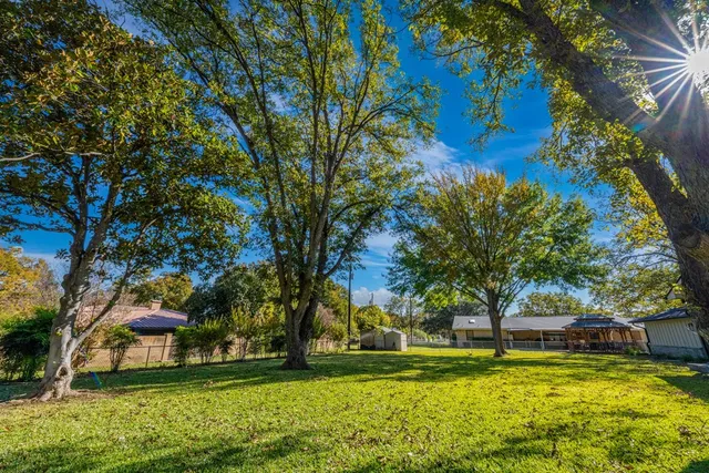 a swimming pool with outdoor seating and yard