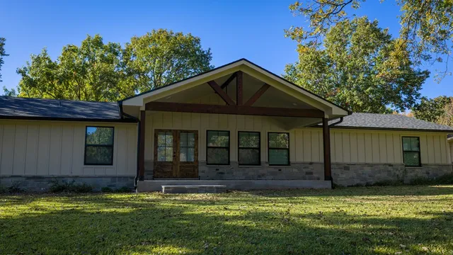 a view of a house with swimming pool and a yard