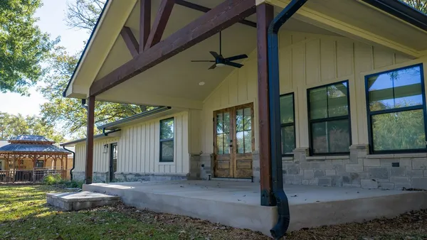 a view of a house with backyard and porch