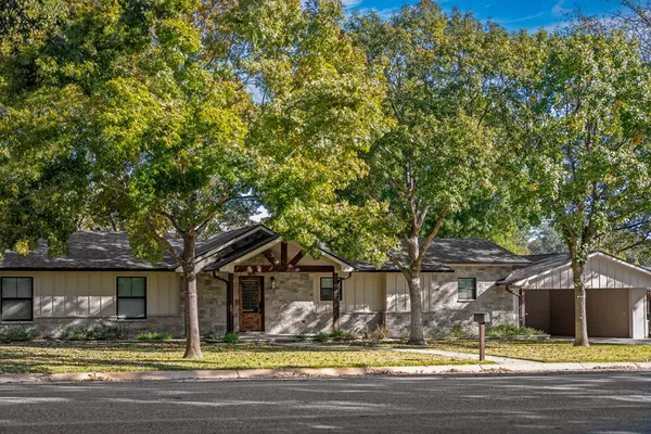 a view of the house with a yard