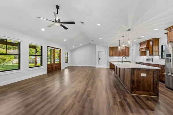 a view of a kitchen with a sink and microwave