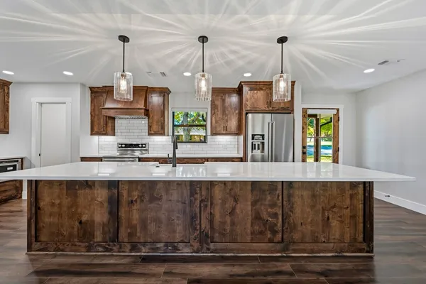a view of a kitchen with a sink and window