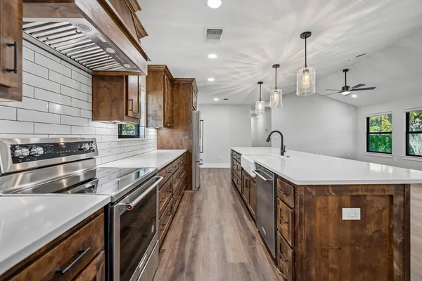 a kitchen with stainless steel appliances a sink and stove